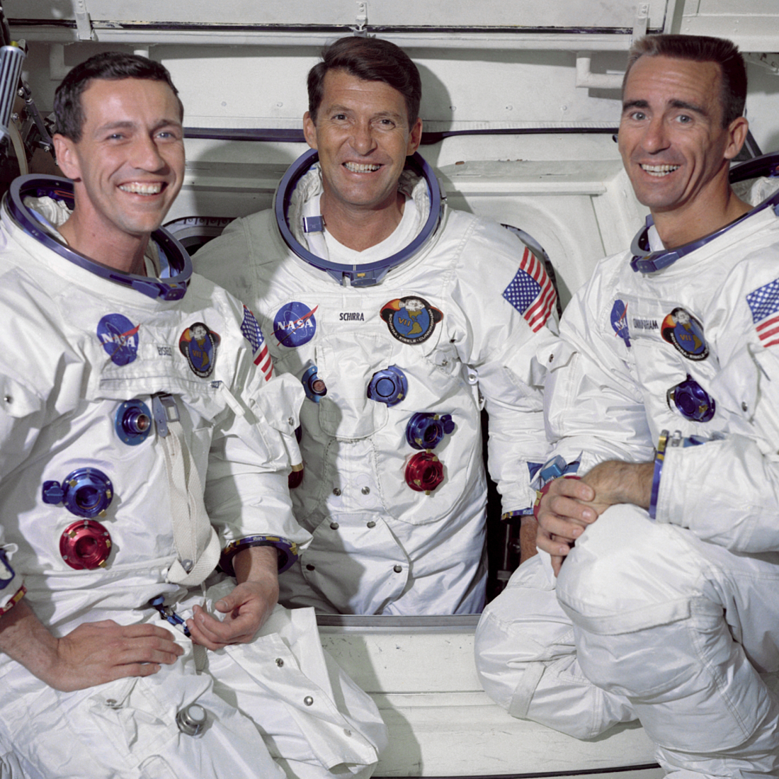 Apollo 7 Crew posing in their space suits.
