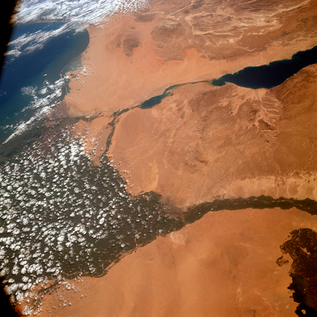 The Nile Delta with neighboring areas of Egypt, the Red Sea, and the Mediterranean Sea as imaged by the Apollo 9 crew for Experiment S065. North is to the left.