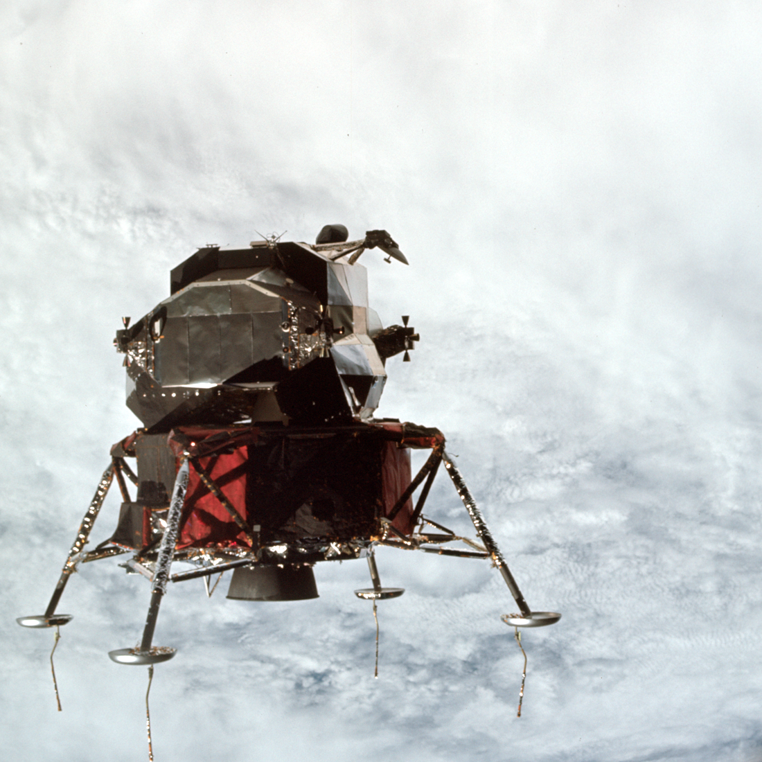 Above a cloudy Earth - another view of Lunar Module Spider.